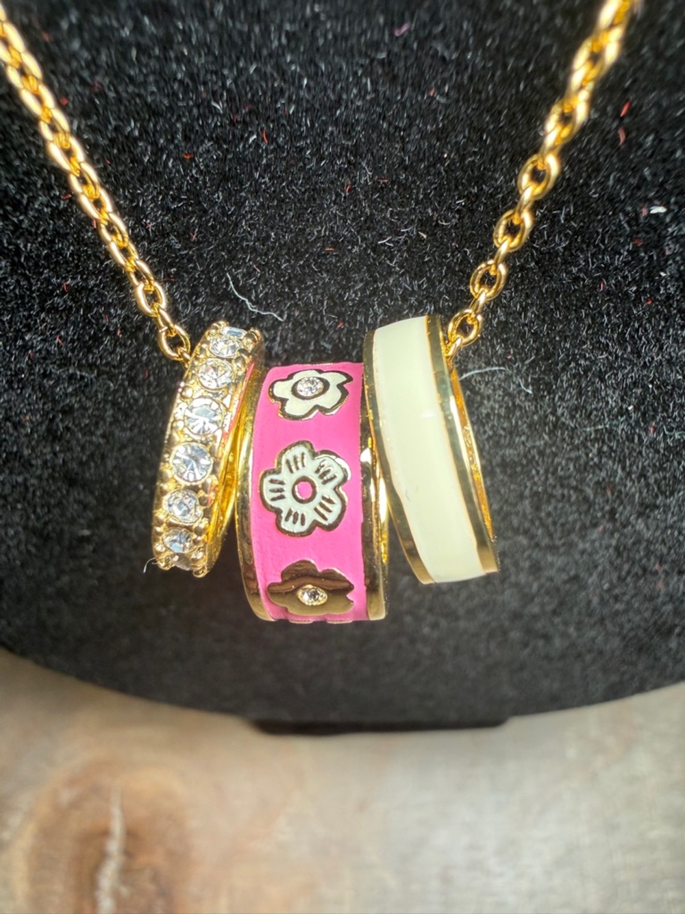 Coach Signature Enamel Rondell Necklace in gold and pink.
